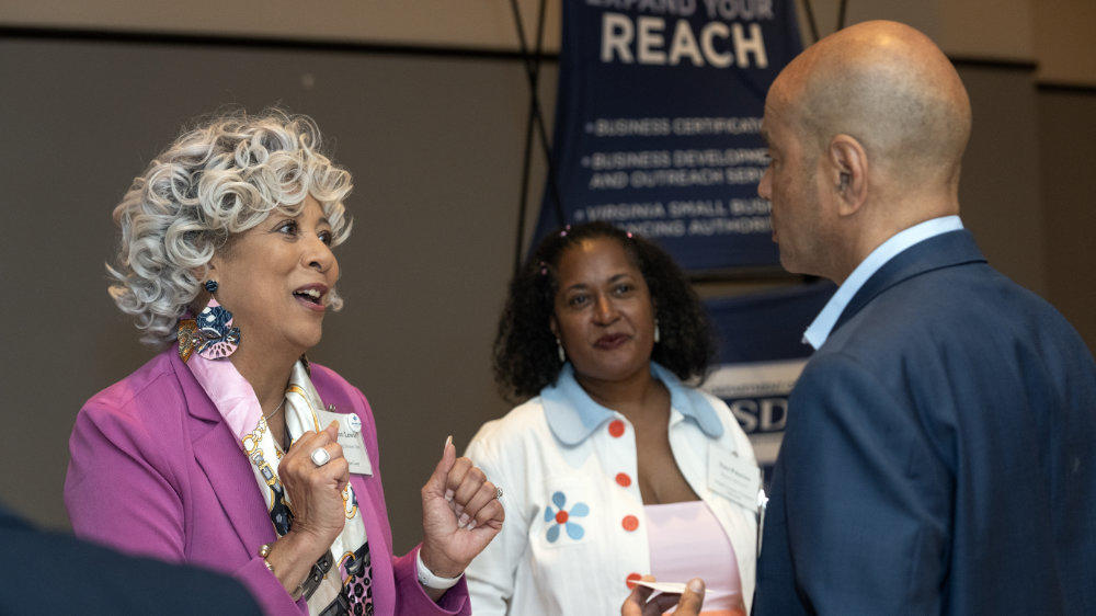 Several individuals converse at a Mason Enterprise networking event.