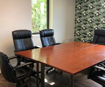 A conference room with floral accent wallpaper